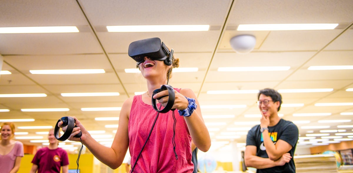 Student with a pink shirt exploring virtual reality